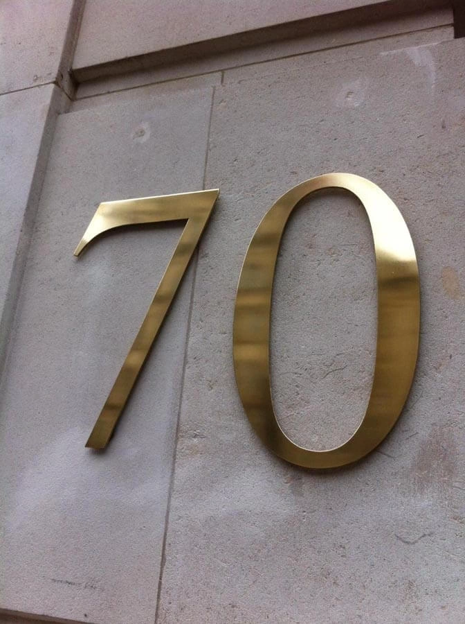 Metal Brass Numbered Signage by AW Sign Services.